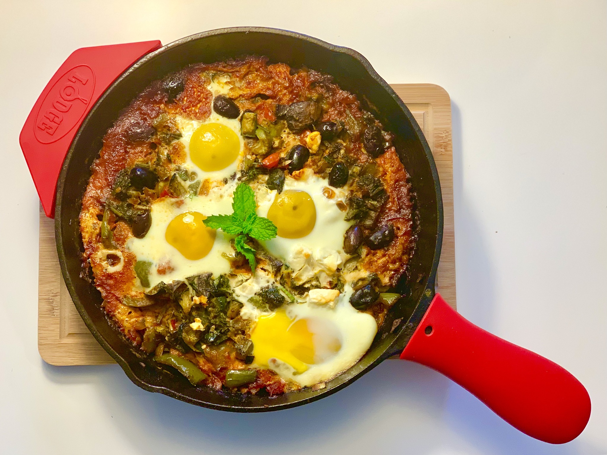 Homemade shakshuka in a cast iron skillet — a Tunisian dish connecting cooking to origins